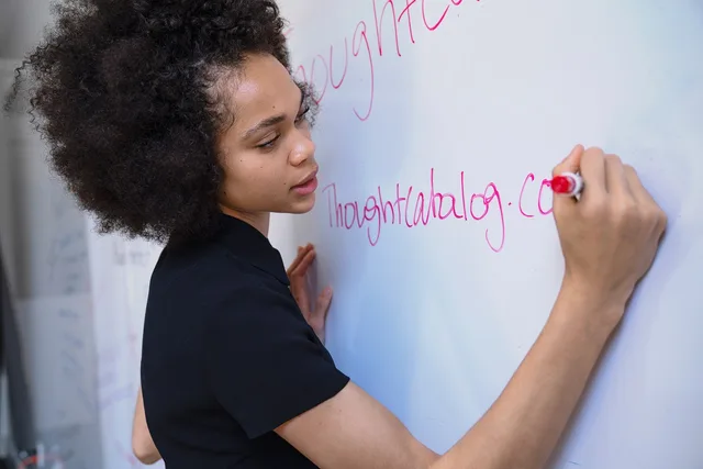 woman, writing, marker, whiteboard, brainstorm, planning, strategy, blue writing, blue plan, blue planning, whiteboard, whiteboard, whiteboard, whiteboard, whiteboard, brainstorm, brainstorm. Comparing Bain and BCG on marketing planning without the guesswork