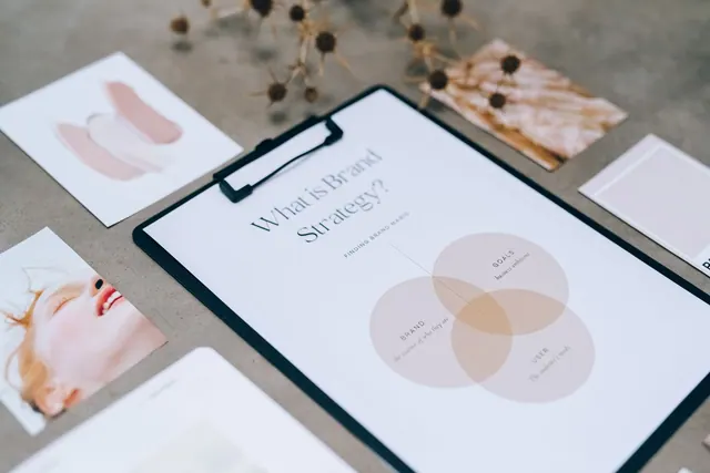 A close-up view of a brand strategy document on a desk surrounded by design artworks. Marketing goals and objectives: a practical guide for 2027